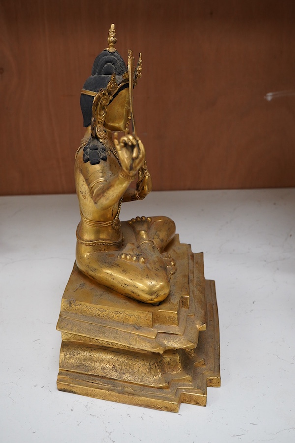 A gilt bronze figure of Manjushri, 31cm